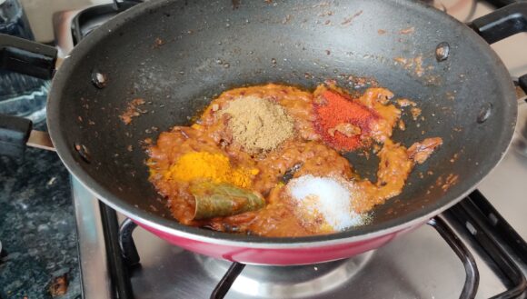 Add salt, turmeric powder, chilly powder, and coriander powder,