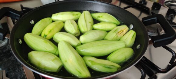 Blanch Parwal (Drop them in boiling water) with a pinch of soda-bi-carb 