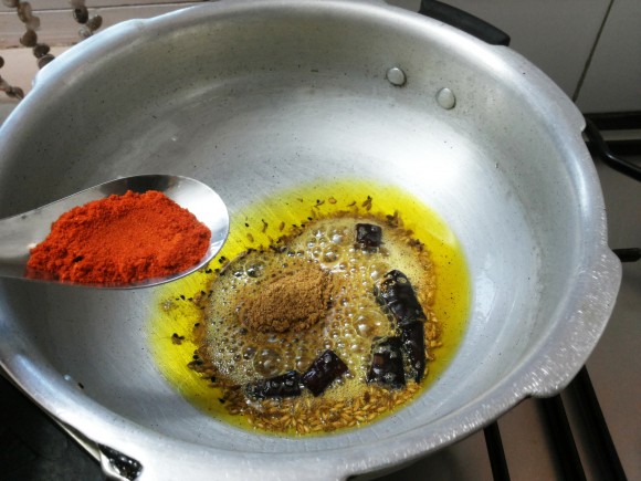 Add turmeric powder, coriander powder and chili powder