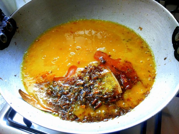 pouring dal into seasoning