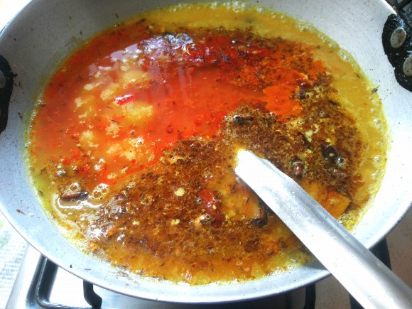 pouring dal into seasoning