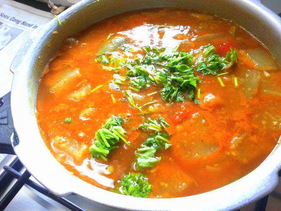 Adding coriander leaves