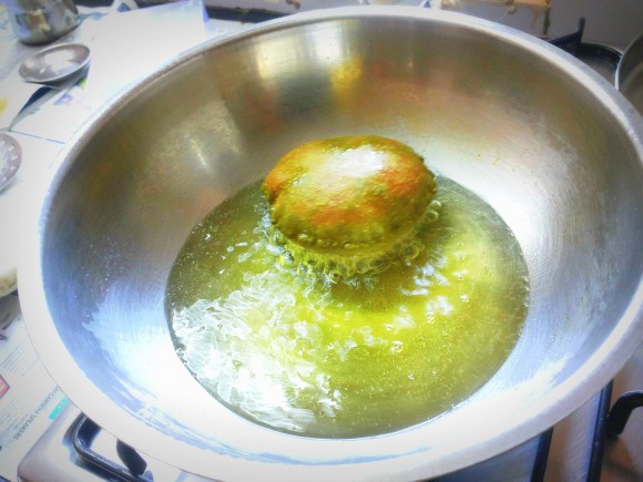 Deep frying the poori 