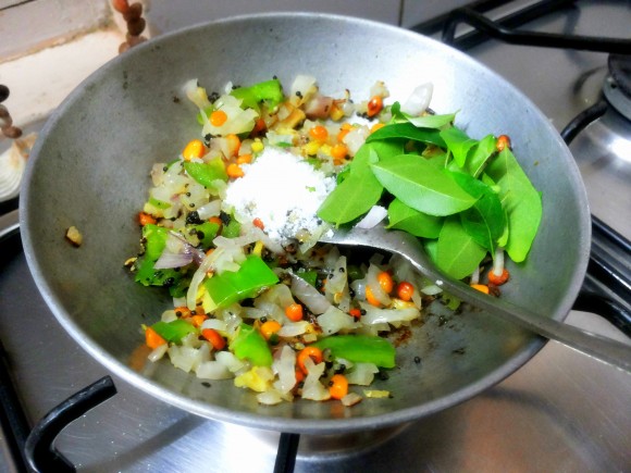 adding salt and curry leaves