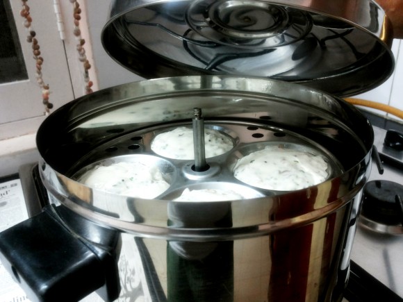 Place the idli stand into the idli cooker 