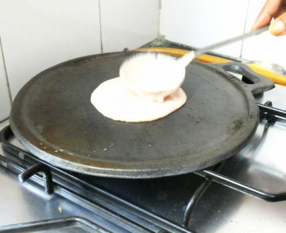 Pour ladleful of dosa batter 