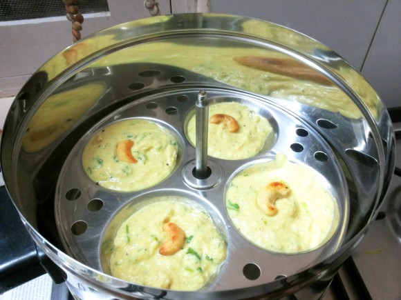 Pour ladleful mixture in idli stand cavity