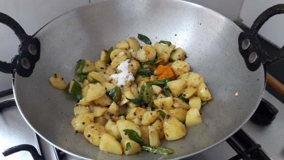 Add salt, turmeric powder and coriander powderand mango powder