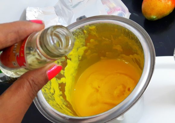 Put the prepared pulp, mango essence and solidified milk in to blending jar