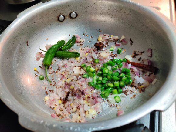 Add garlic shoot, green chili and garlic paste