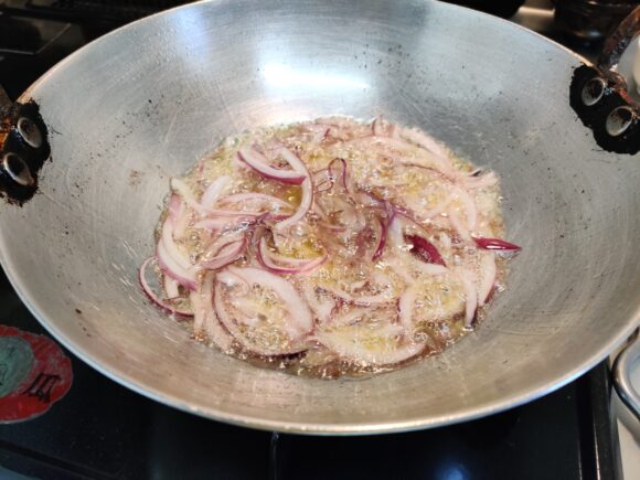 Deep fry 150 gm of onion on high flame 