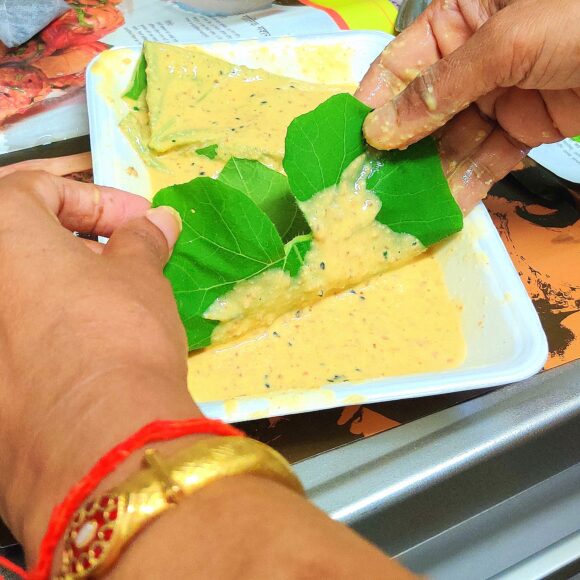 dip one leaf in the prepared batter of Besan