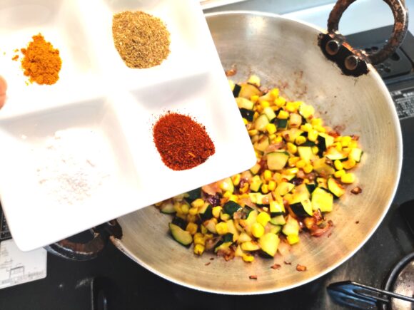 add Turmeric powder, Coriander powder, Chili powder, Dry mango powder and salt