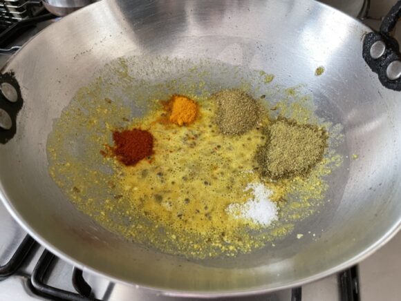 Add salt, turmeric, chilli, coriander, and cumin powder,