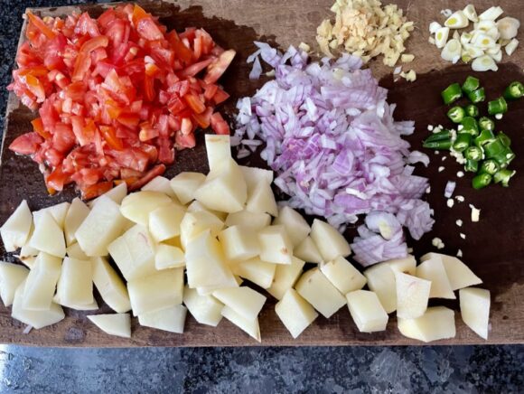 Chop onion, tomato, garlic, green chilli and ginger