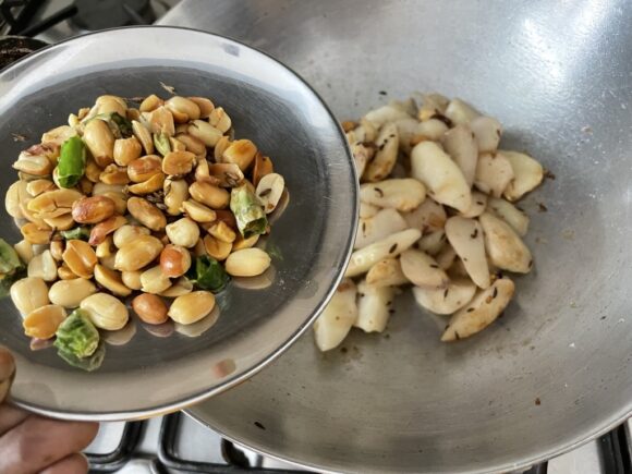 Add  fried peanuts and green chilli