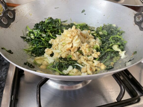 add coarsely ground mixture of peanut and green chilli along with half of the fried garlic