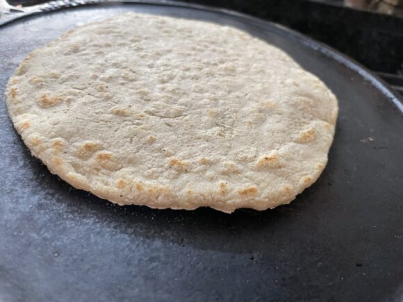 slightly rotate the roti by pressing gently