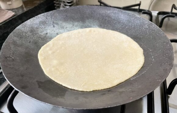 Put this rolled chapati into the hot tawa