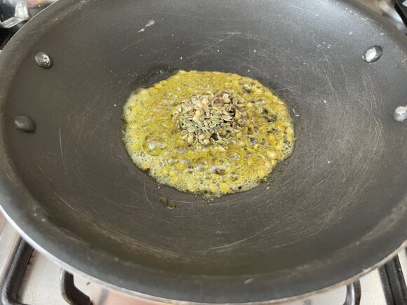 add all crushed ingredients of stuffing along with asafoetida powder, sputter for a minute on low flam.