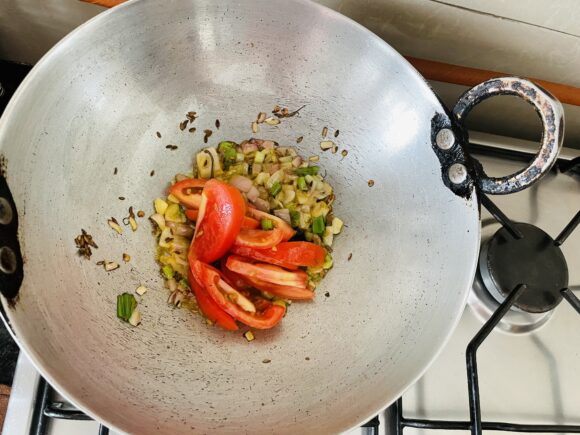 Add tomatoes, green chilies, and ginger-garlic paste