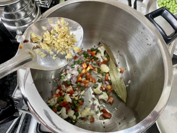 Add onion, fresh peas and ginger