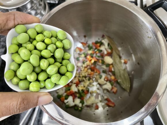 Add onion, fresh peas and ginger