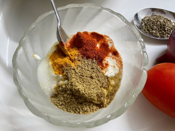 Prepare wet masala by adding coriander powder, turmeric, chilli powder and salt in curd